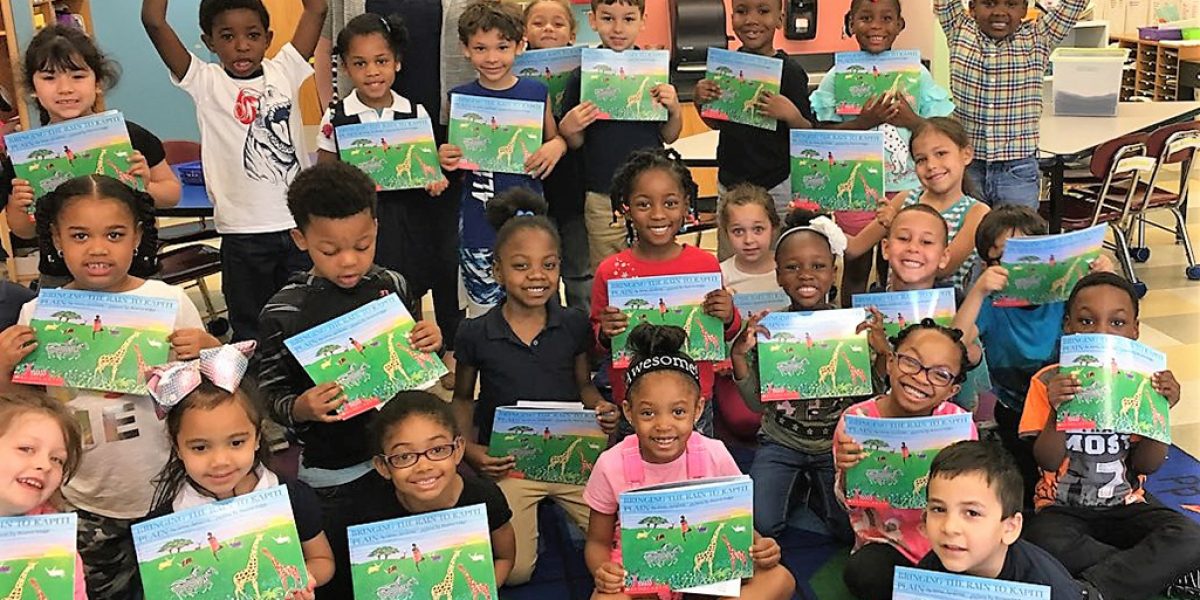 Children in Dawn Miller’s kindergarten class at the Manthala George Elementary School in Brockton pose with their books after their 45-minute class with SSC ImagineARTS Specialist, Holly Jennings in 2018. Courtesy image.