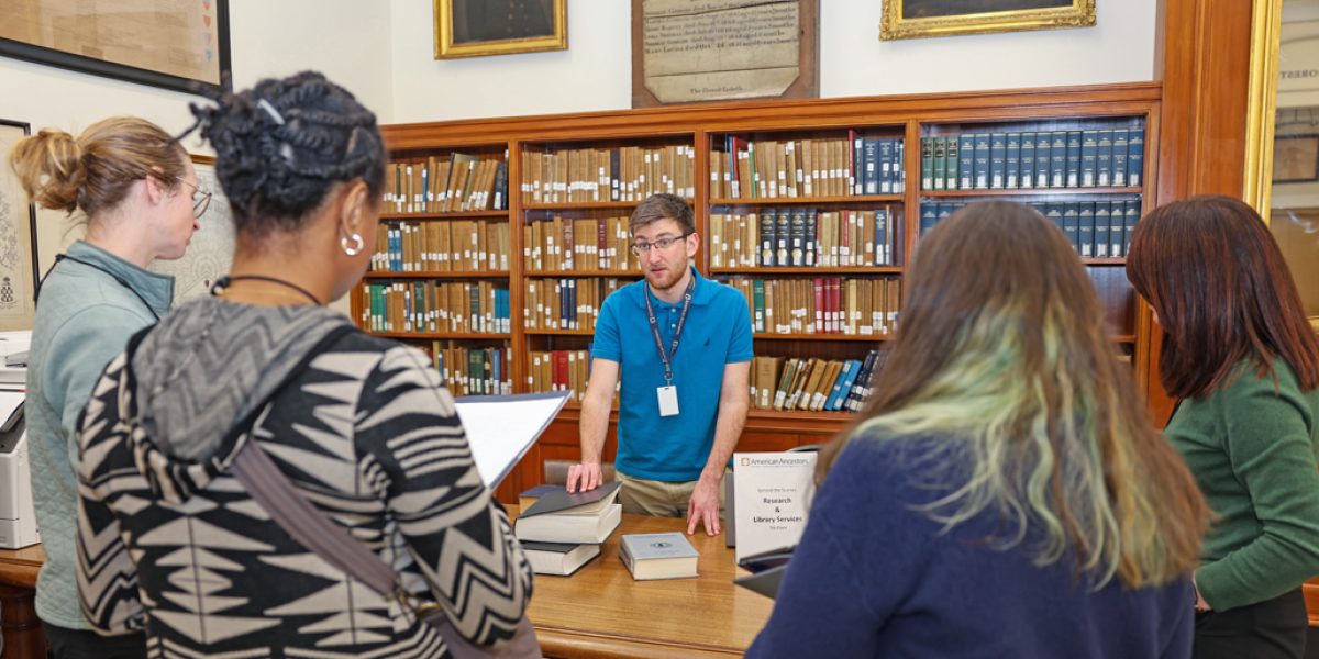 American Ancestors' Library Services Coordinator Aidan Walsh introduces teachers to the nonprofit's research library collections during a professional development program in Boston, image by Claire Vail Photography.